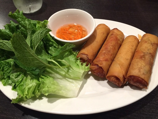 Crispy fried pork egg rolls with lettuce leaf, mint and tangy dipping sauce. Photo by Michael Baehr