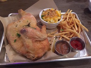 The half chicken entrée with shoestring fries and mac-n-cheese