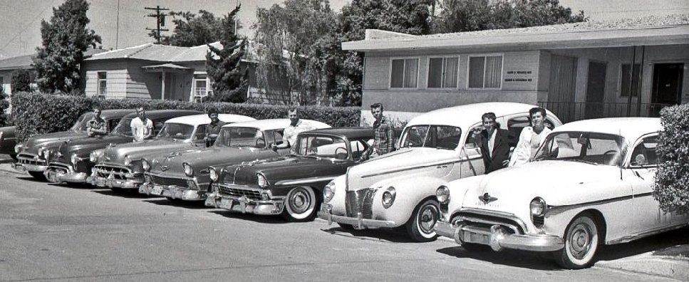 The original 1950s Bay Park Boys and their cars on Chicago Street: (L to R) Darold Dwinell, Neil Dwinell, Wayne Buck, Neal Remmerde, Ray Bentsen, David Buck, Tommy Tipton (photo by Bob Lampert) 